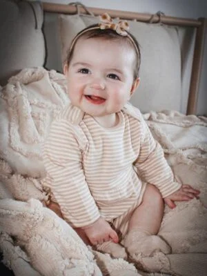 fodla smiling wearing organic cotton baby romper