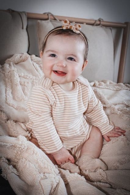 fodla smiling wearing organic cotton baby romper