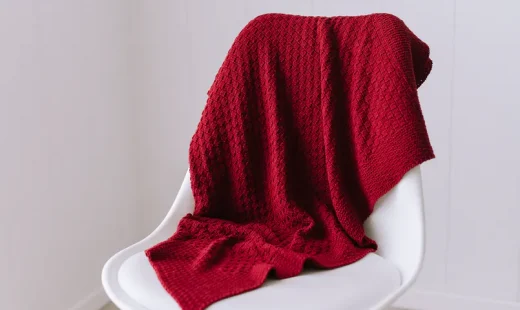 organic cotton baby blanket, red on a white chair