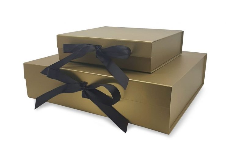 gold gift box with black ribbon