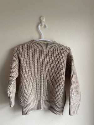 back of beige oversize knit sweater