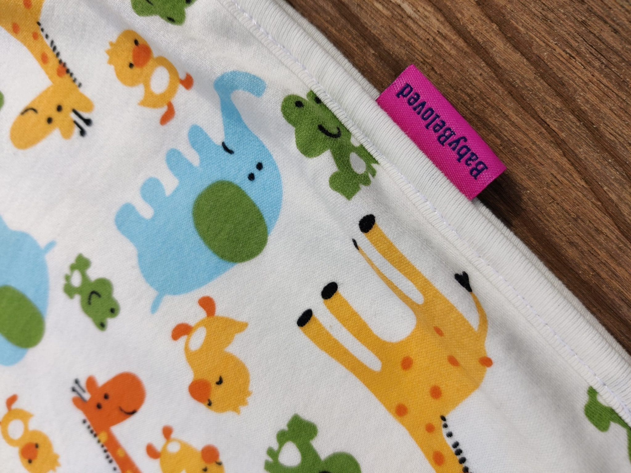 picture of organic cotton baby sleeping bag with animals print. picture of the logo