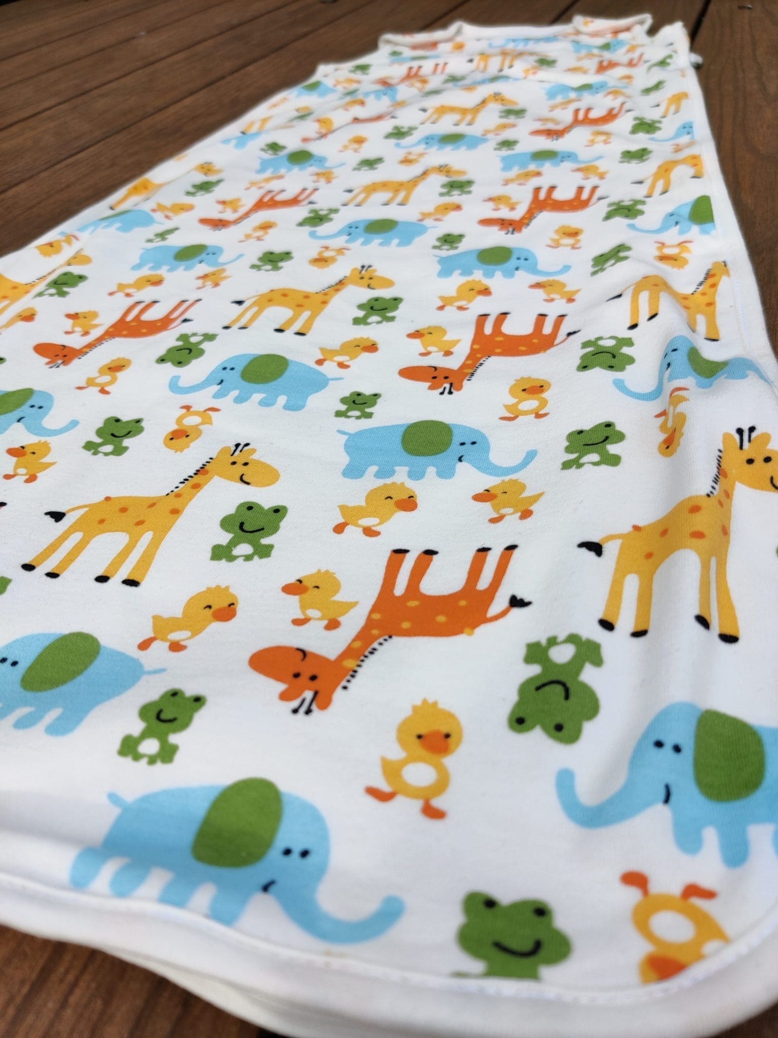 picture of organic cotton baby sleeping bag with animals print. picture of the logo